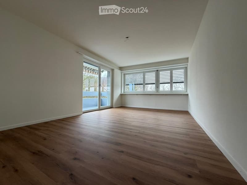 empty room, wooden floor, white walls, sliding glass doors, windows, balcony