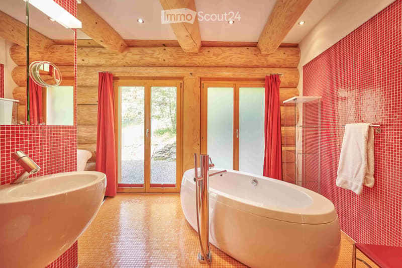 Bathroom: wooden wall, large window, red wall tiles, modern bathtub, white sink, red chair