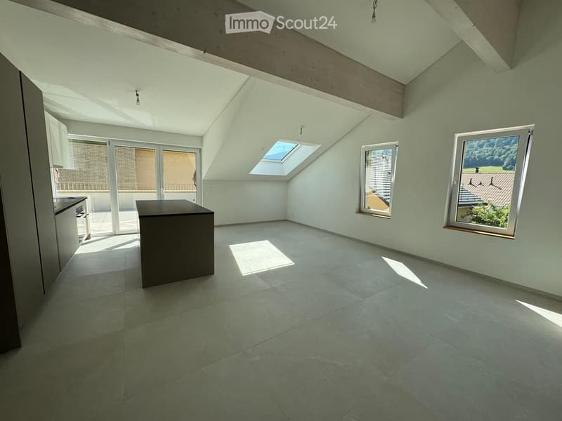 Empty room with light green walls, tiled floor, skylight, and large windows. Minimalist design with no furniture.