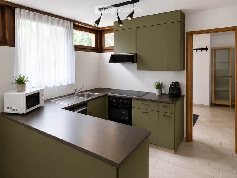 Modern kitchen with green cabinets, stainless steel appliances, and a central island. Features include a microwave, sink, oven, induction cooktop, coffee maker, and potted plants on the counter.