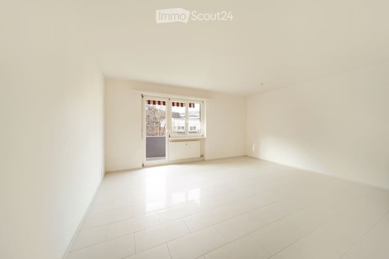 Empty room with white walls, white tiled floor, and large window with blinds. No furniture or equipment present.