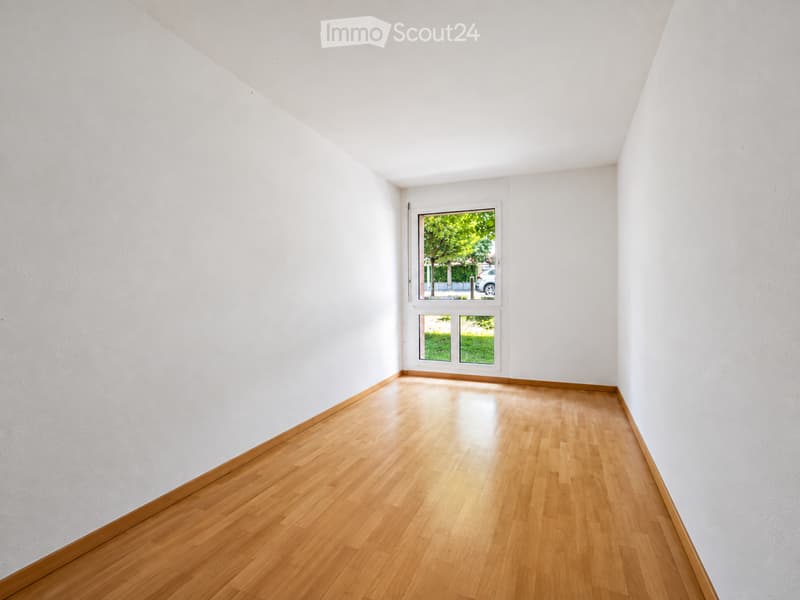 Completely empty room with bare white walls and wooden floor. No furniture or equipment.