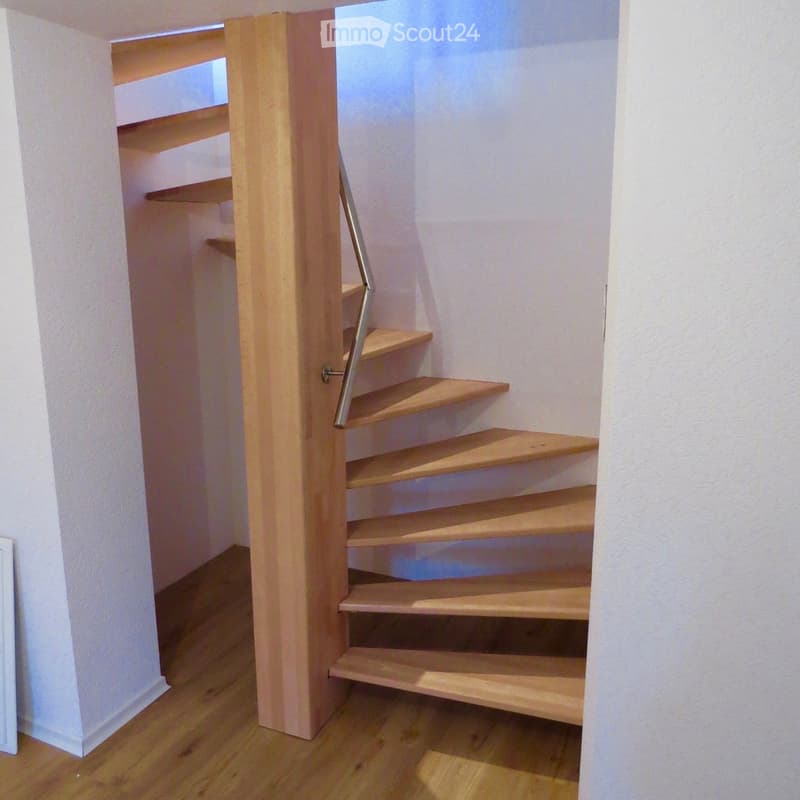 wooden staircase, metal handrail, white walls, wooden floor
