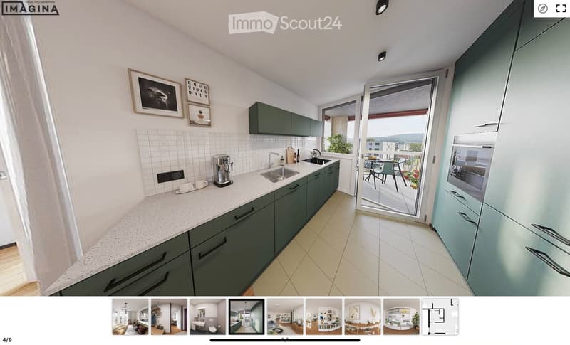 Modern kitchen with green cabinets, white tiled backsplash, and a large window opening to a balcony. Features include a sink, coffee maker, and framed pictures on the wall.