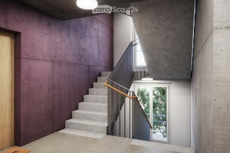 Modern hallway with a staircase featuring concrete steps and a metal railing, illuminated by natural light from a window at the end.