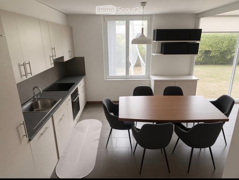 Modern kitchen and dining area with white cabinets, stainless steel sink, oven, pendant light, and a wooden dining table with six black chairs.