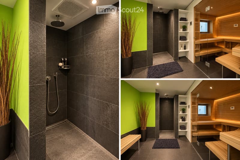 Modern bathroom with dark grey tiles, a glass-enclosed shower area, wooden sauna bench, built-in shelves, and a potted plant. The space features sleek fixtures and ambient lighting.