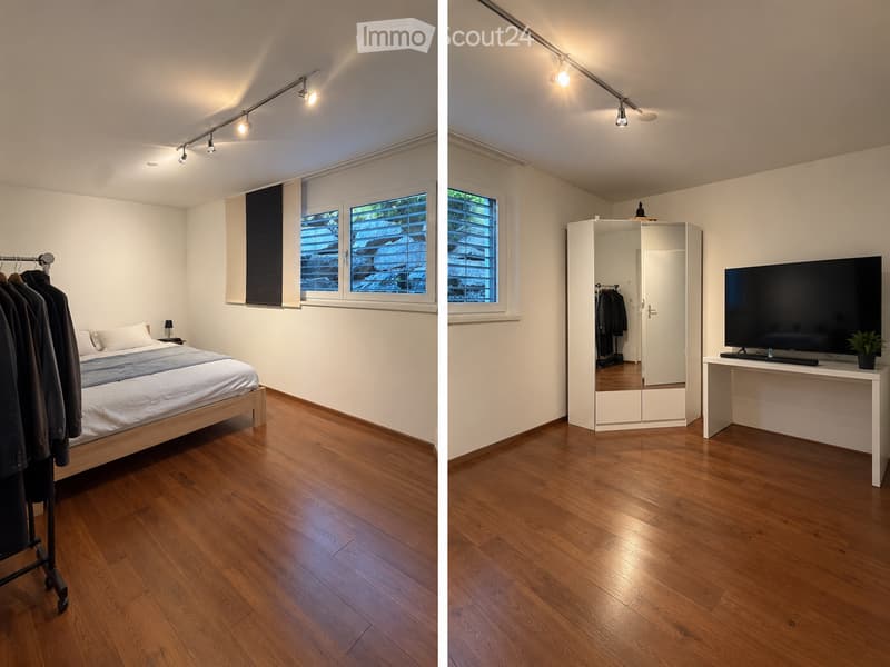 Modern bedroom with wooden flooring, large window with blinds, bed with white bedding, nightstand, mirror wardrobe, TV on a table with a small plant.