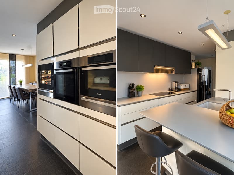 Modern kitchen with white and black cabinets, stainless steel appliances, island with bar stools, and a dining area with a table and chairs.