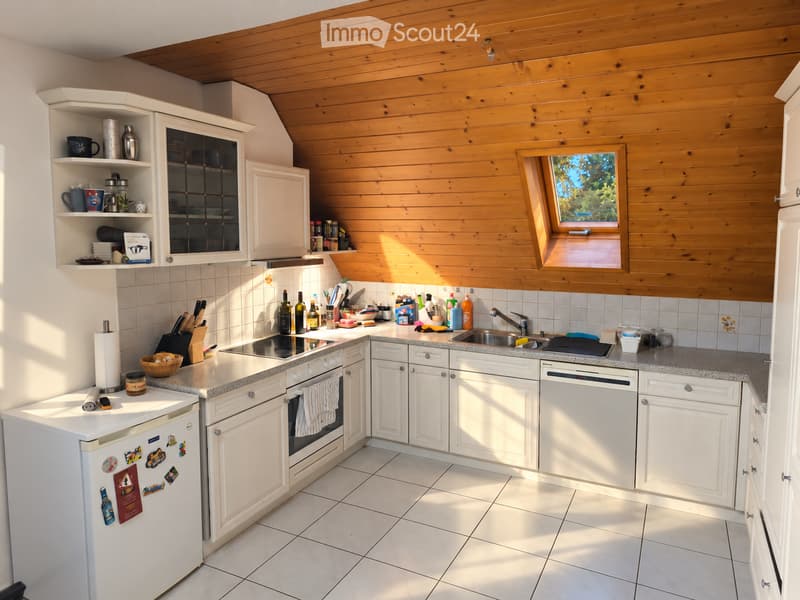 {"type": "Kitchen", "objects": ["refrigerator", "oven", "sink", "faucet", "cabinets", "countertop", "knife block", "wine bottles", "cupboard", "bowl", "fridge magnets", "cup", "bottle", "cupboard", "cupboard", "cupboard", "cupboard", "cupboard", "cupboard