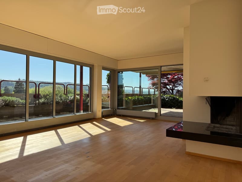 Unfurnished Room. Bright, unfurnished room with large floor-to-ceiling windows, wooden flooring, and a fireplace.