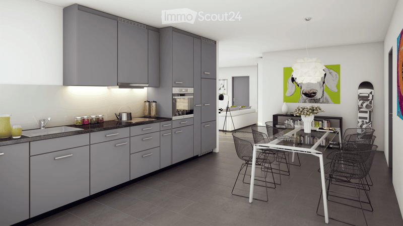 Modern kitchen with grey cabinets, stainless steel appliances, and a dining area with a white table and black wire chairs. The space features a sleek design with a large window and contemporary decor including a cow-themed artwork and a small living area