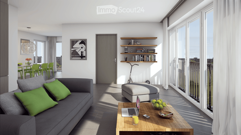 Modern living room with large windows and balcony access, featuring a grey sofa with green cushions, wooden coffee table with laptop and bowl of fruit, ottoman, shelves with books and decor, and a dining area with green chairs.