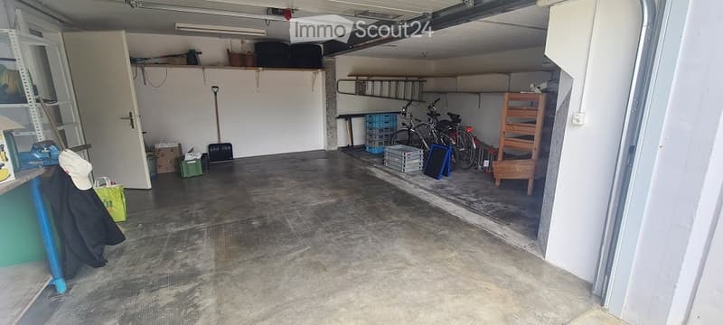 {"visible_features": ["Garage"], "type": "Garage", "objects": [], "description": "Clean, organized garage with concrete floor, shelving units, bicycles, and various stored items including ladders, tools, and crates.", "localized_descriptions": {"EN": "Cle
