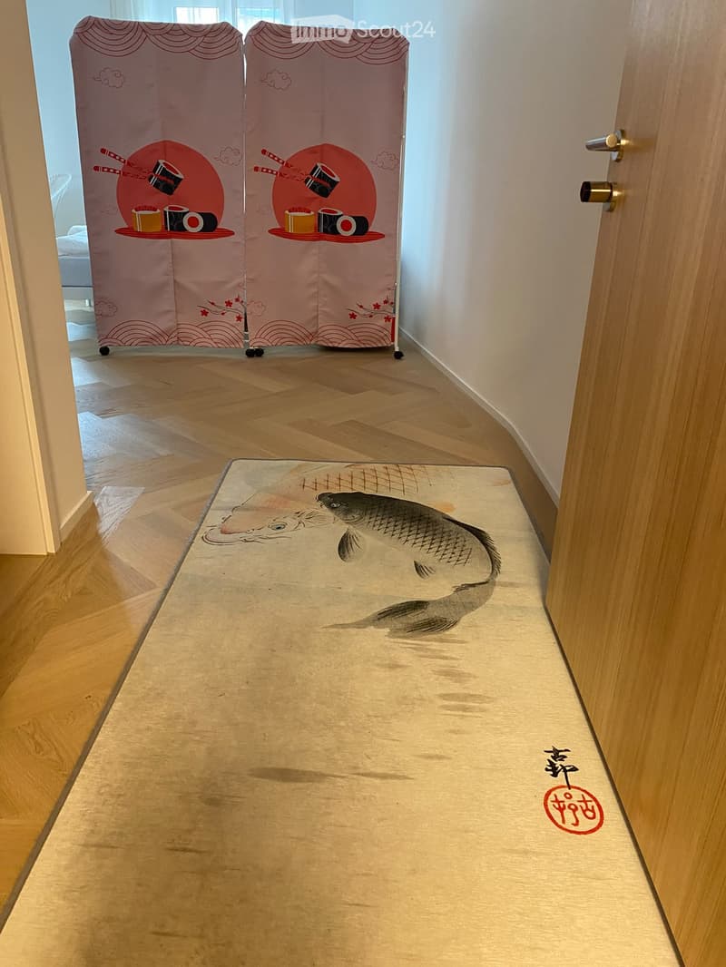 Hallway with wooden flooring, a large fish rug, and a decorative screen with sushi and Japanese motifs.