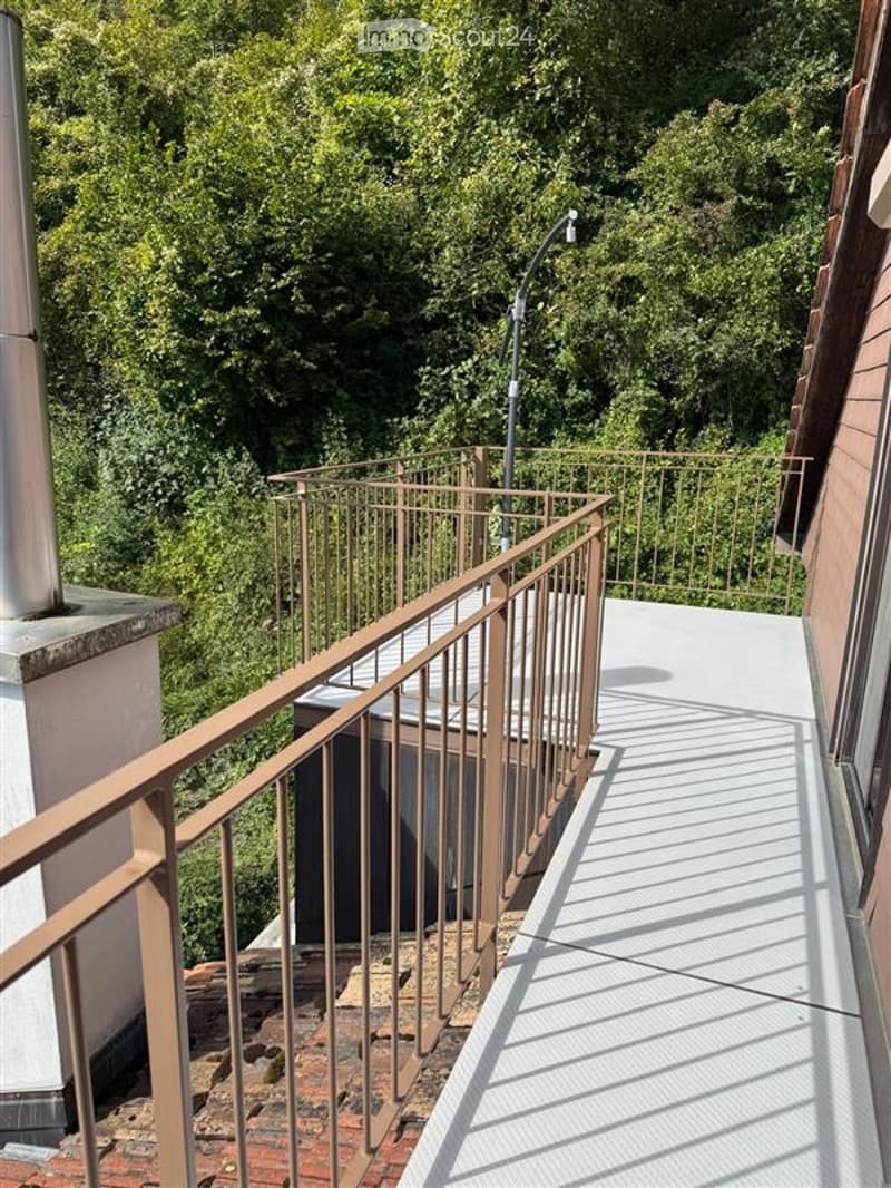 elevated terrace with railings, hot tub, shadow of railings on floor