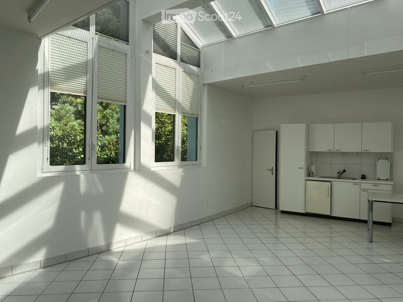 Bright, minimalist kitchen with white tiled floors, white cabinets, and large windows with blinds. Features a sink, faucet, refrigerator, and a small table.