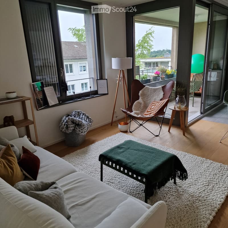 living room with couch, rug, chair, table, plants, lamps, view