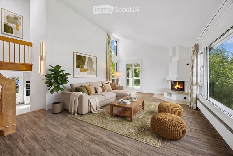 Modern living room with a sectional sofa, coffee table, ottomans, fireplace, large windows with a view, and decorative artwork.
