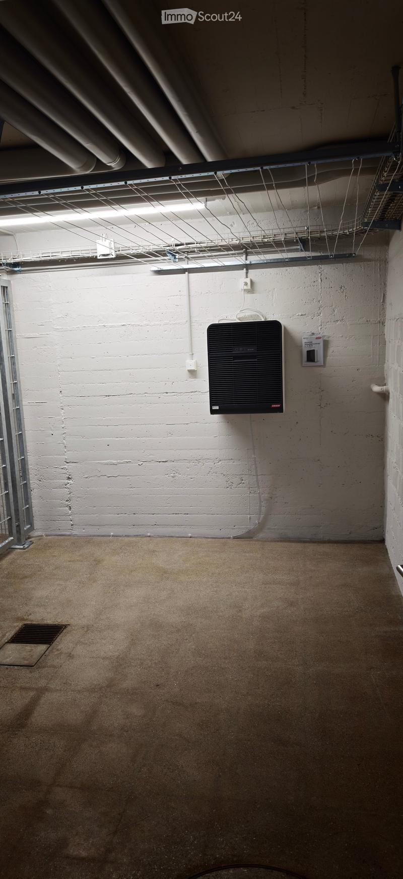 Empty basement or utility room with exposed brick walls, concrete floor, and a mounted electrical panel.
