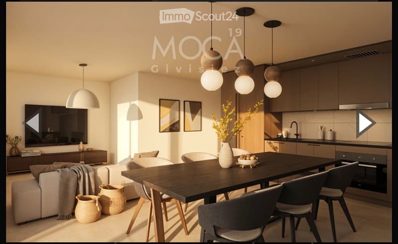 Open-plan living and dining area with modern furniture, including a sofa, coffee table, dining table with chairs, and a kitchen area with cabinets and a faucet. Pendant lights hang above the dining table, and decorative items such as a vase with flowers,