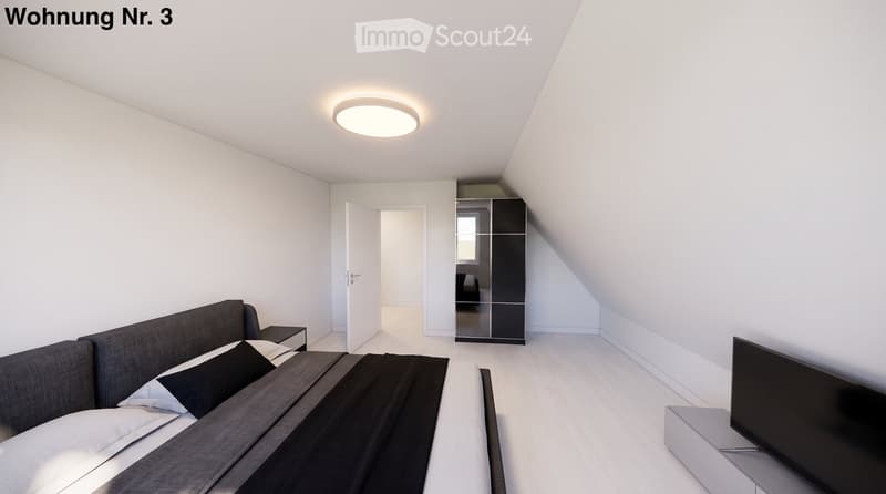 Modern bedroom with a grey sofa, nightstand, wardrobe with mirror, and television on a stand. The room features white walls, wooden flooring, and a recessed ceiling light.