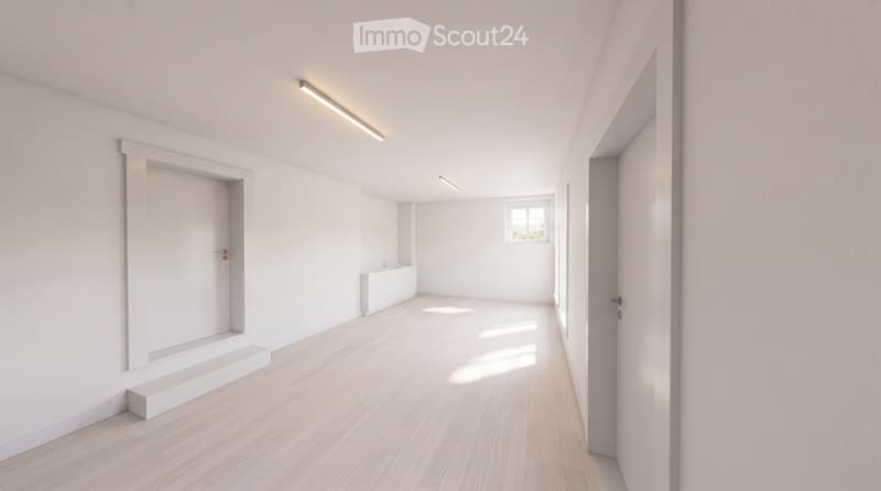 Empty room with light wooden flooring, white walls, and recessed lighting. Features a small window and a built-in bench along one wall.