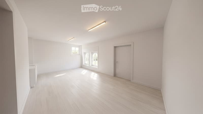 Empty room with light wooden flooring, white walls, and large windows allowing natural light. No furniture or equipment is present.