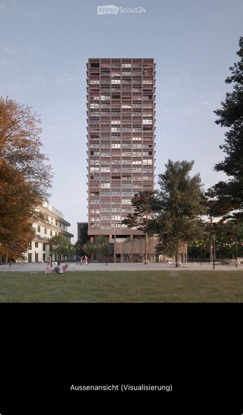 A modern high-rise building with a grid-like facade, surrounded by trees and a grassy area with people sitting and walking.