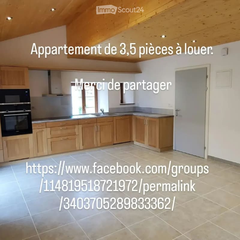 Bright kitchen with light wooden cabinets, stainless steel oven, sink, and faucet. The space features tiled flooring and a large window allowing natural light to enter.