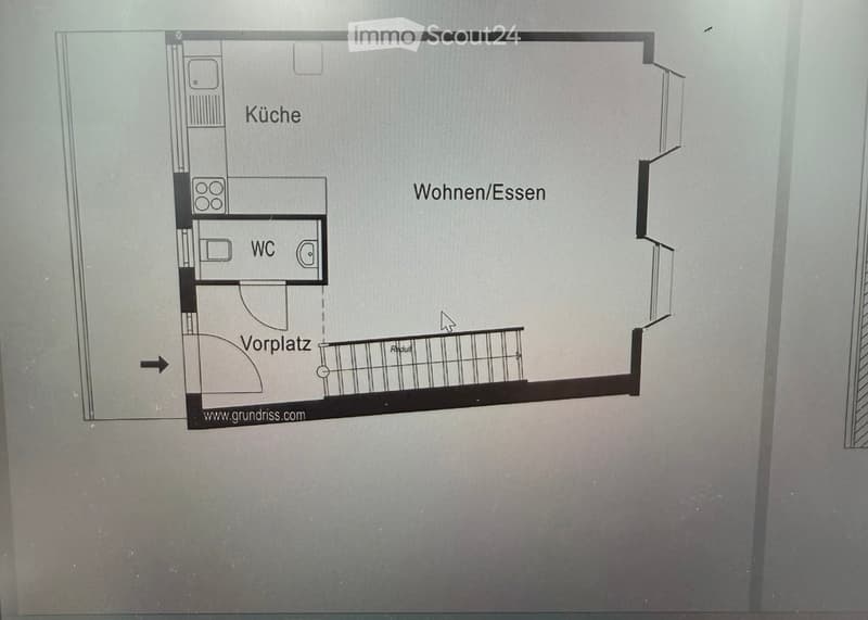 Floor plan showing a kitchen, living/dining area, bathroom, and entrance area with a balcony.