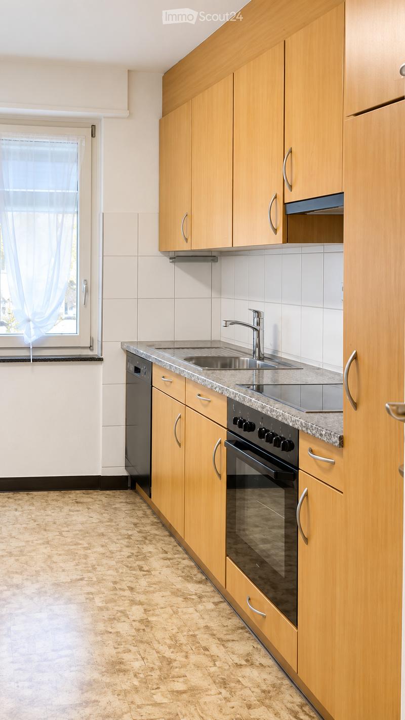 Modern kitchen with light wooden cabinets, granite countertop, stainless steel sink and faucet, built-in oven and dishwasher, and tiled backsplash.