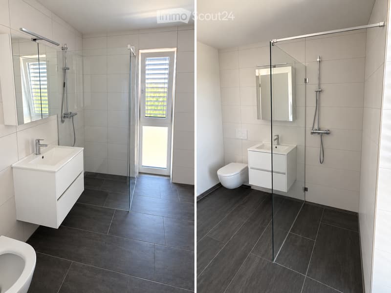 Modern bathroom with white tiles, dark flooring, glass shower enclosure, sink, mirror, and toilet.