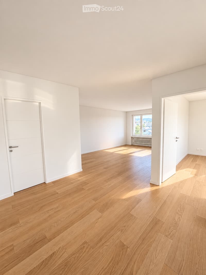 Empty room with light wooden flooring, white walls, and a window letting in natural light. No furniture or equipment is present.