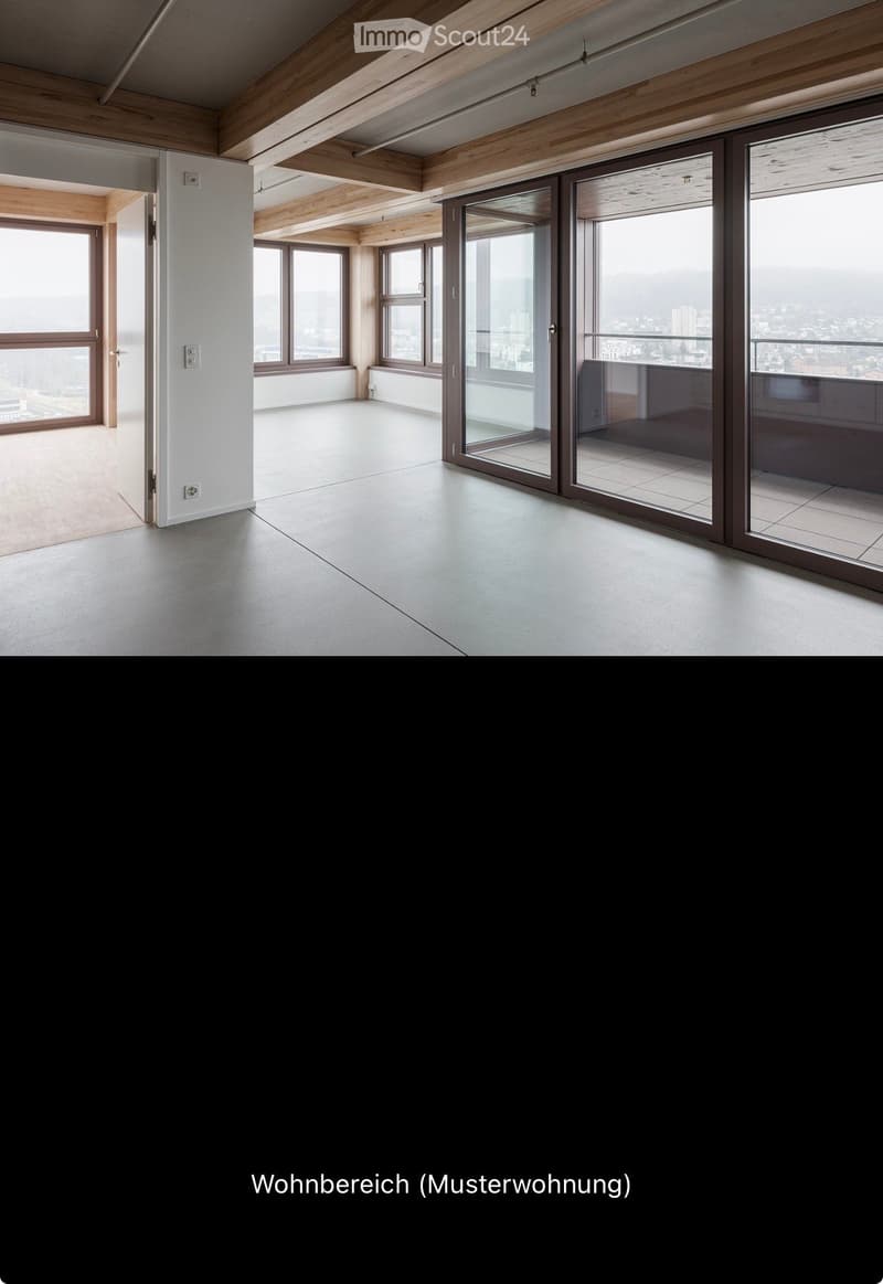 Empty room with wooden ceiling beams, large windows, and sliding glass doors leading to a balcony.