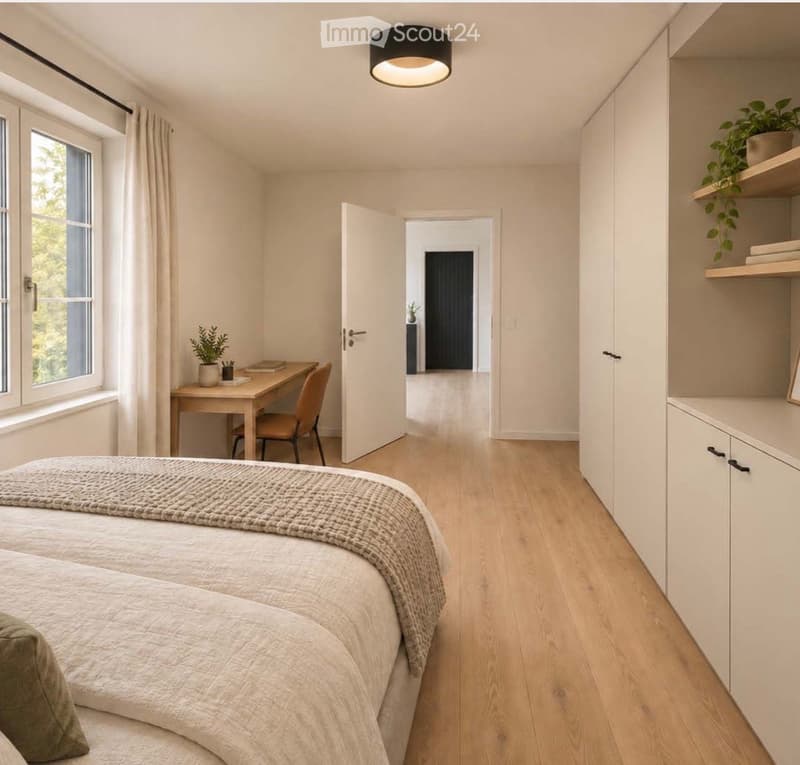 Bright bedroom with two single beds, a desk with a chair, built-in white cabinetry, and a shelf with a plant. Large windows with curtains and a hallway leading to another room.