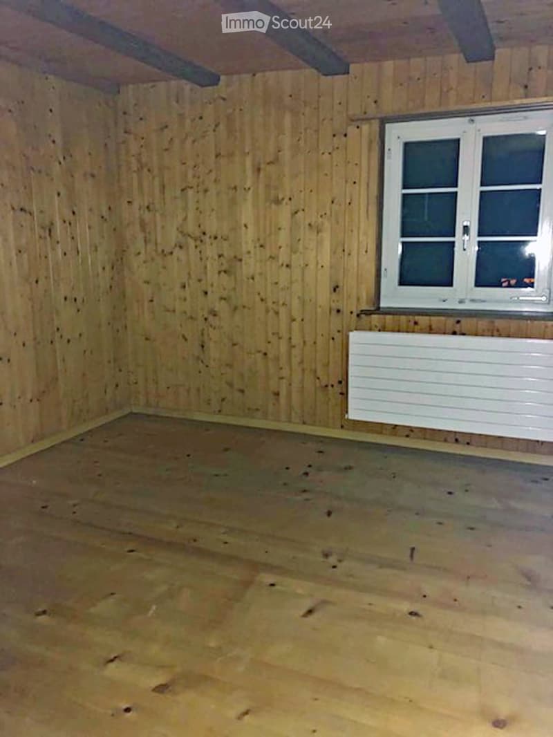 empty room, wooden walls, hardwood floors, white window, white radiator