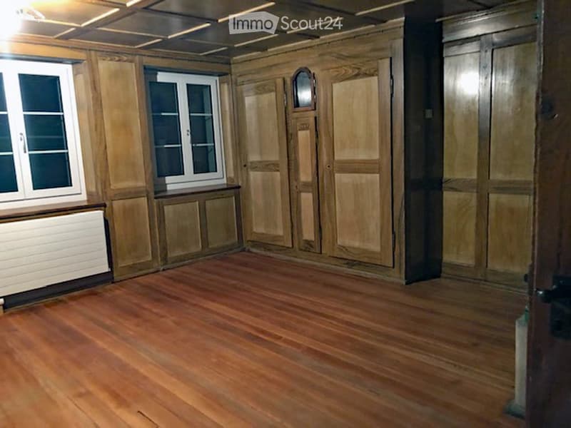 empty room, wooden flooring, wooden panels, windows, closets