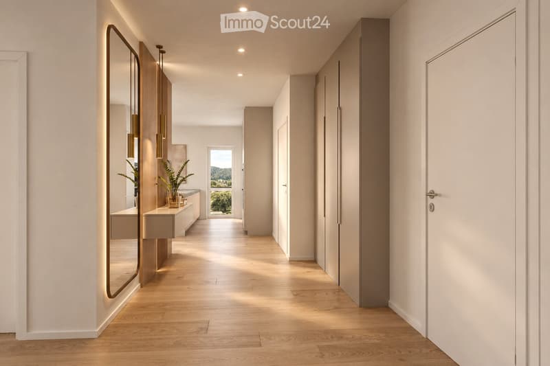 Modern hallway with light wooden flooring, white walls, recessed lighting, and a large mirror on one side. A small plant and a bench are visible in the background, with a view of the outdoors through an open doorway.