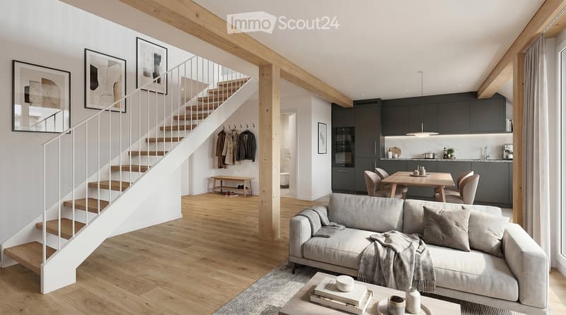Modern living and dining area with exposed wooden beams, a grey sofa, coffee table, dining table with chairs, and a staircase leading to an upper level.