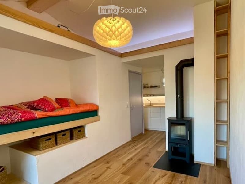 wooden bed, cozy pillows, wooden floor, fireplace, wooden ceiling, hanging lamp