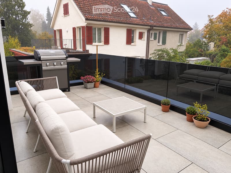 Modern balcony with a white sofa, coffee table, barbecue, and potted plants, overlooking a house with red shutters and a garden.