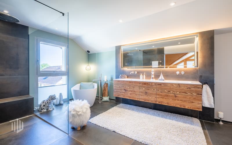 Eine grosse Dusche, die freistehende Badewanne und ein Doppellavabo verbinden hier eine stilvolle Gestaltung mit hohem Komfort.