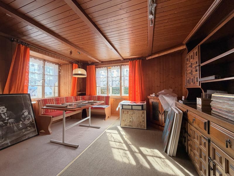 wooden walls, wooden floor, large windows, table, bench, picture, cabinets, books, lamp