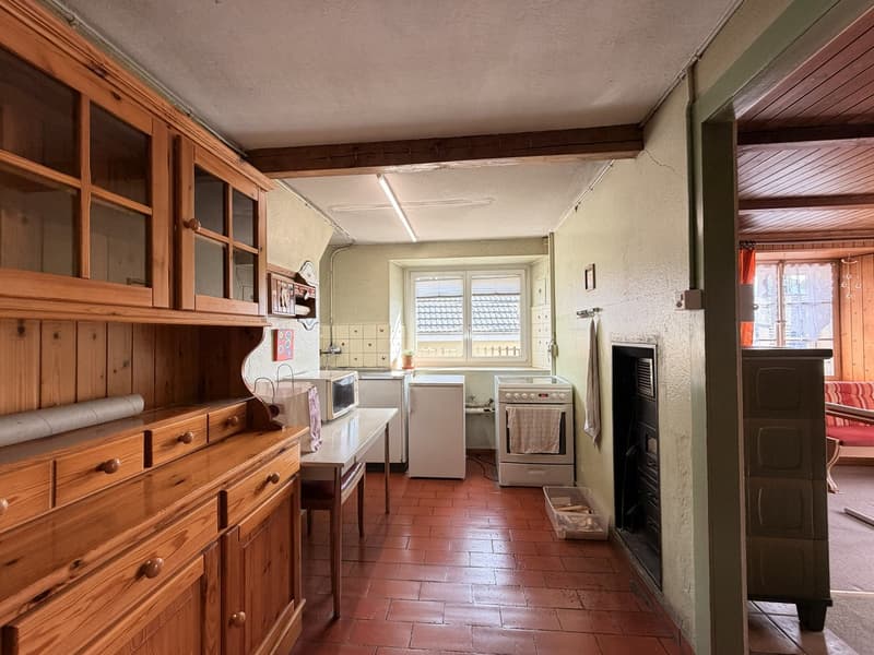 wooden cabinets, white appliances, fireplace, red tile floor