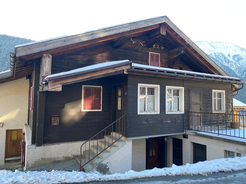 Detached house, wooden facade, red shutters, balcony, stairs, snowy area