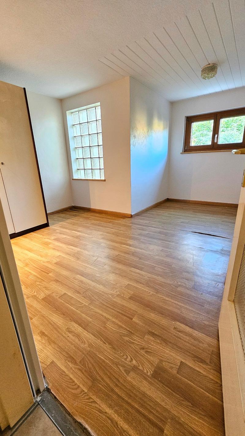 empty room, wooden flooring, white walls, glass window, wooden window frame