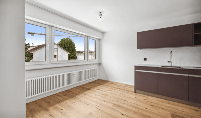 empty room, wooden floor, white walls, large windows, radiator, kitchen with sink and faucet