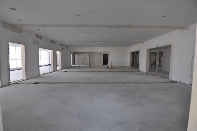 Concrete floor, multiple windows, unfinished walls, ceiling