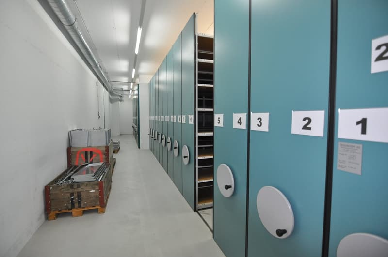storage room with numbered lockers and pallet of boxes